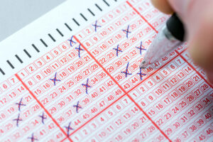 Completing a lottery ticket with a pen and hoping for quick riches